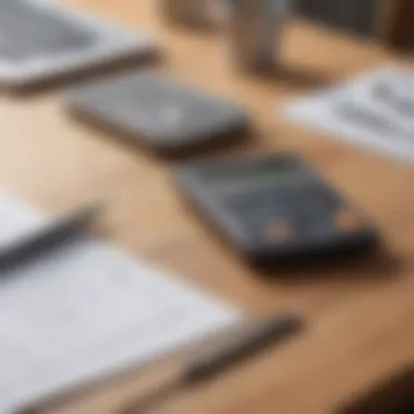 A calculator, notepad, and pen on a wooden desk, representing budgeting